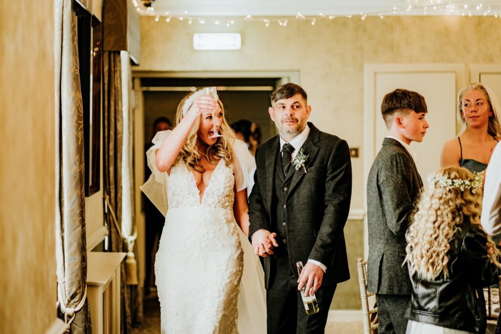 Bridal couple walking into their wedding reception at Banchory Lodge Hotel