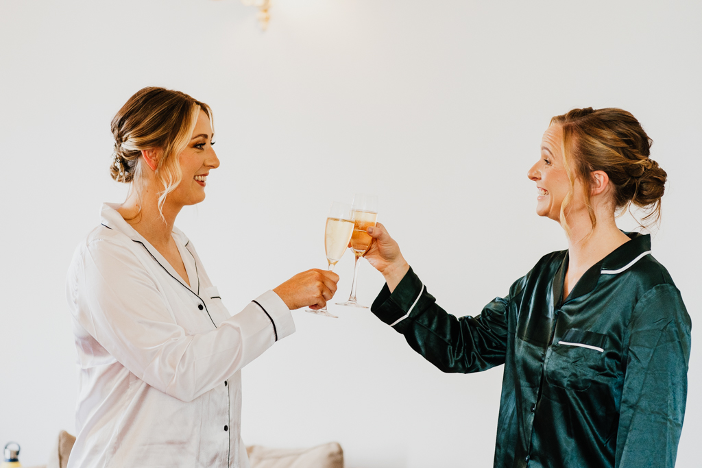 two women with champagne glasses in their pajamas