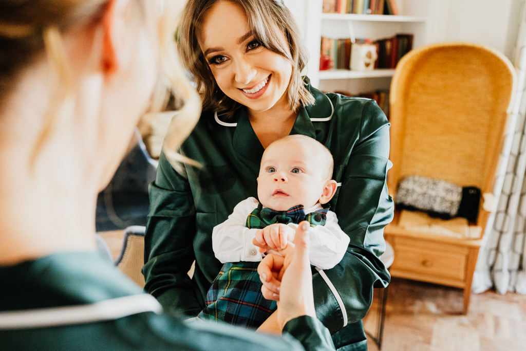 woman holding a baby and smiling