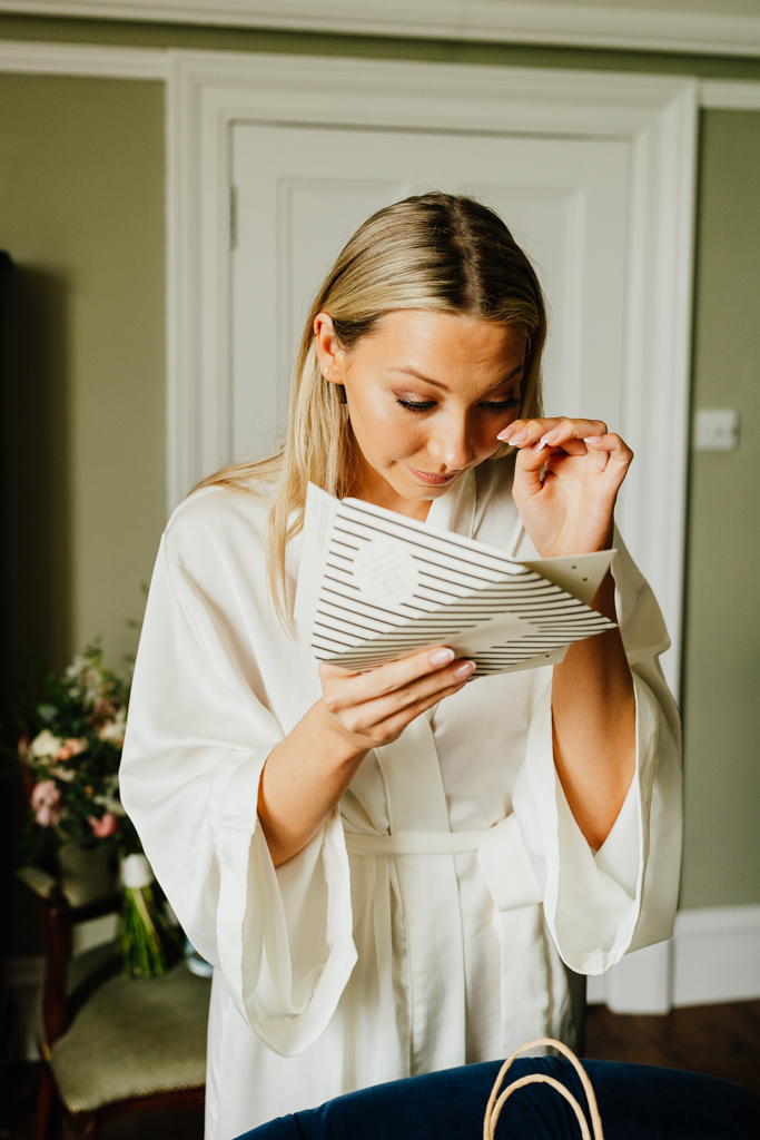 bride crying as she reads a wedding card