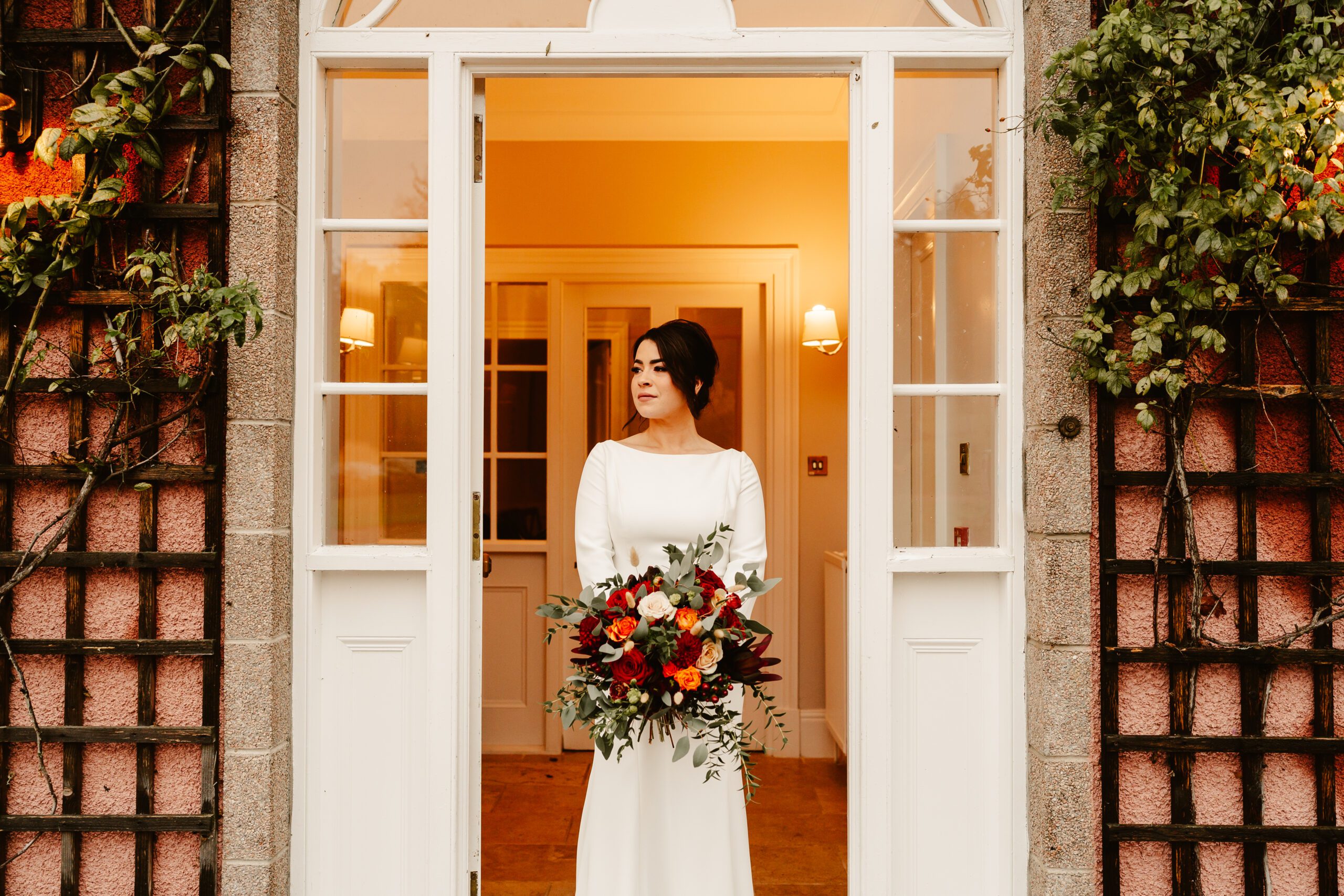 Bride poses in the doorway at Ballogie House