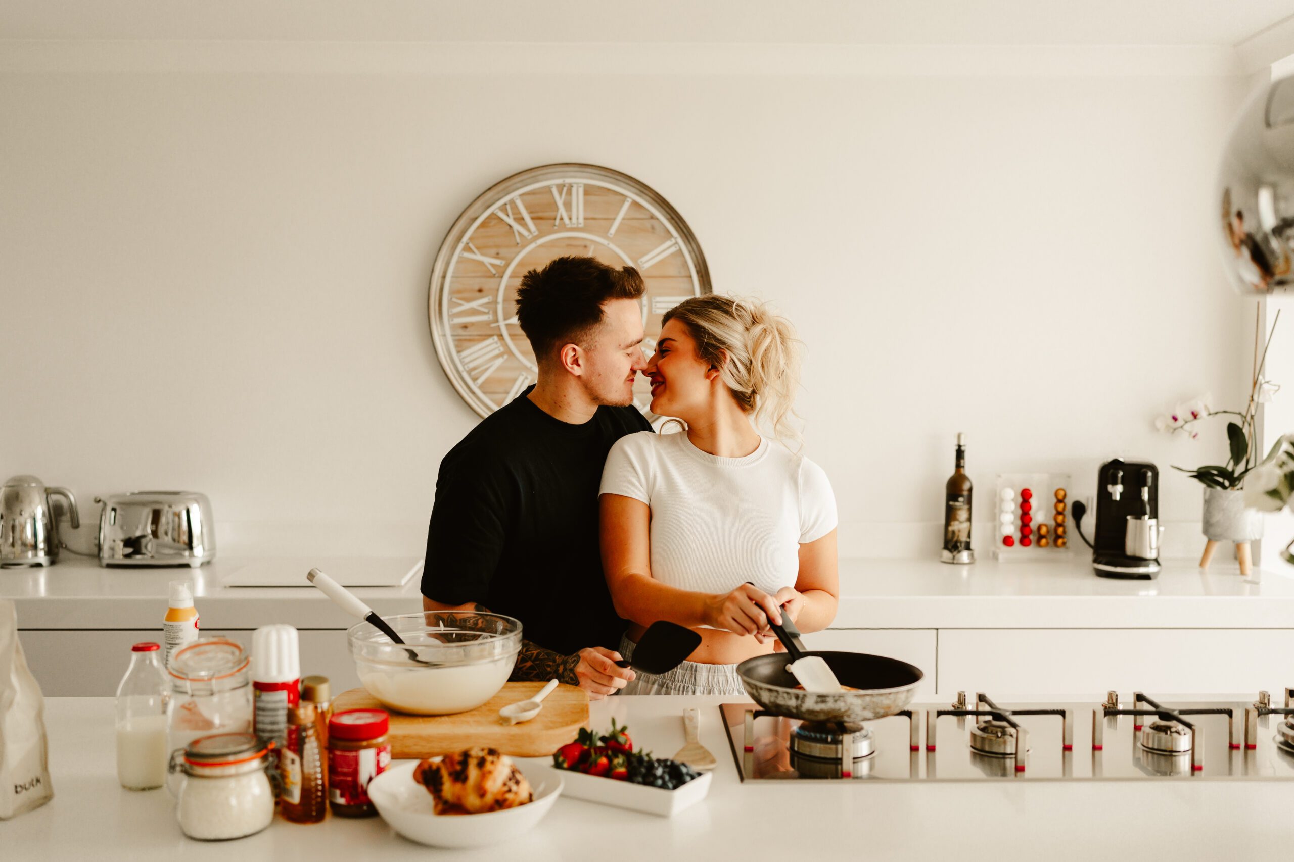 Couple cuddle whilst making pancakes at home Aberdeen pre wedding photos