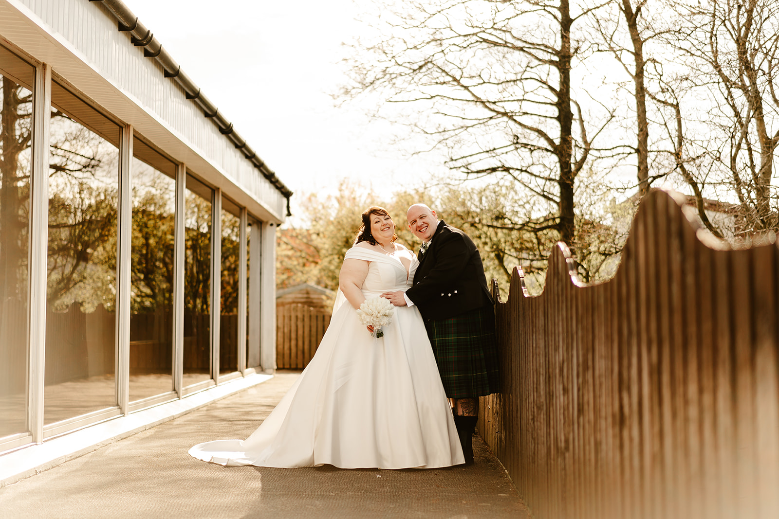 bride and groom pose at the the three kings falkirk scottish wedding venue