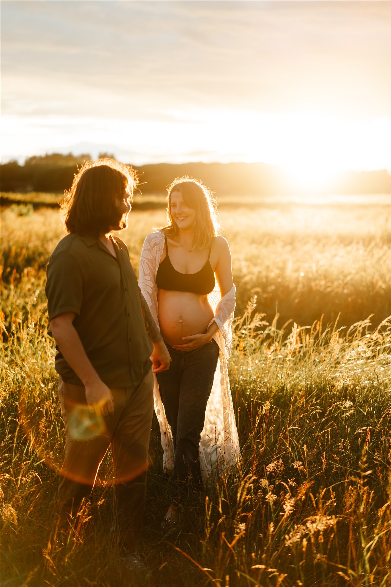 Couple walk hand in hand during maternity photoshoot at balmedie beach aberdeen