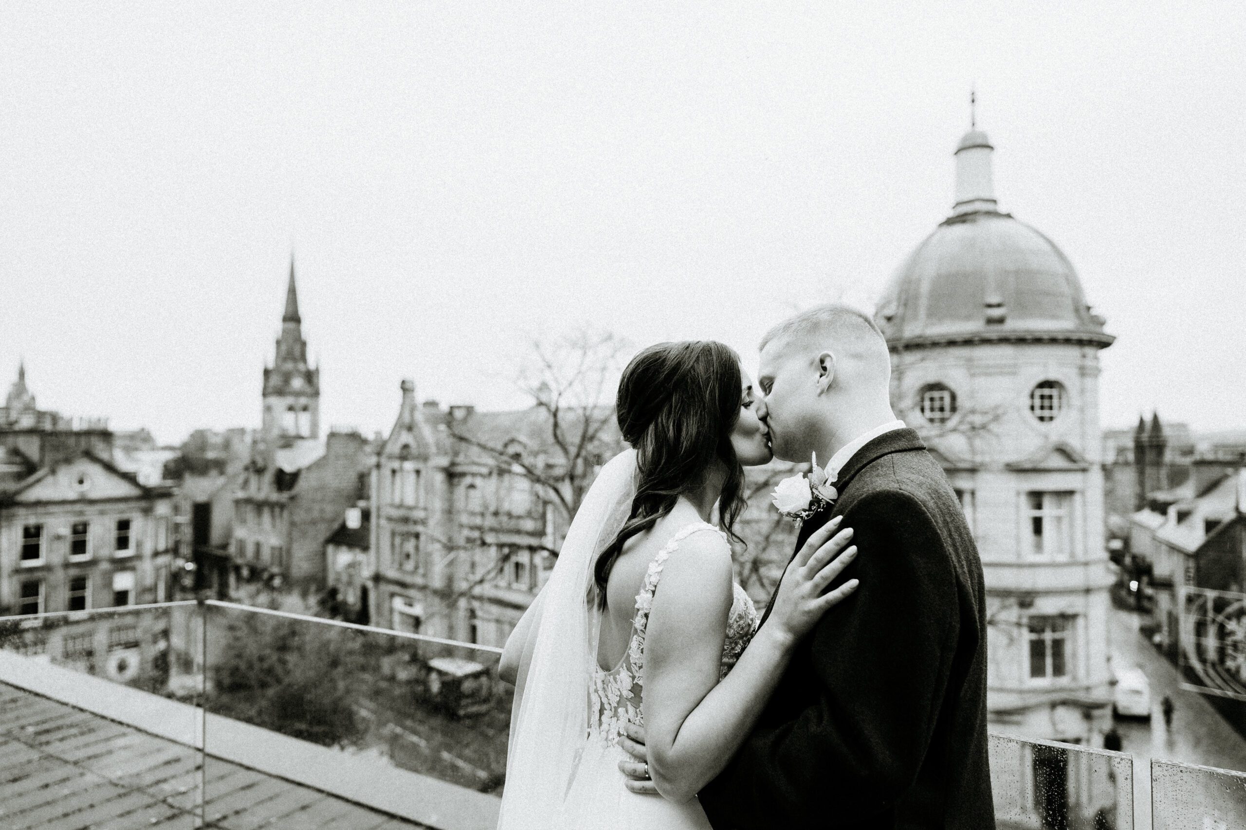 bride and groom kiss at Aberdeen city centre wedding art gallery